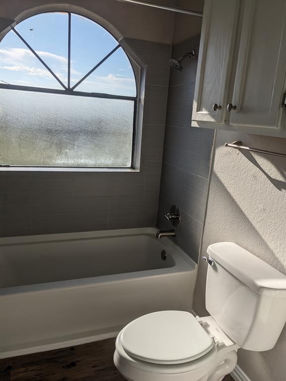 6108 Abrams Road, Unit 325 Dallas, TX 75231 - Photo 7 of 13 a white toilet sitting next to a bath tub