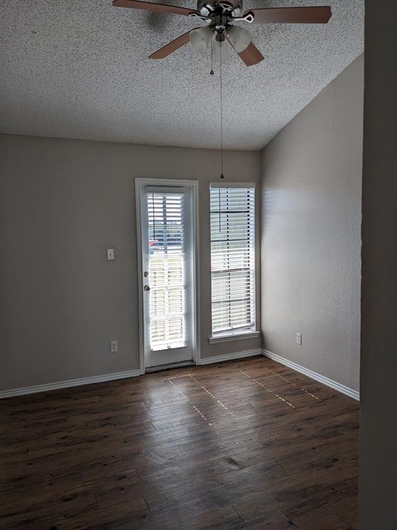 6108 Abrams Road, Unit 325 Dallas, TX 75231 - Photo 8 of 13 an empty room with wooden floor chandelier fan and windows
