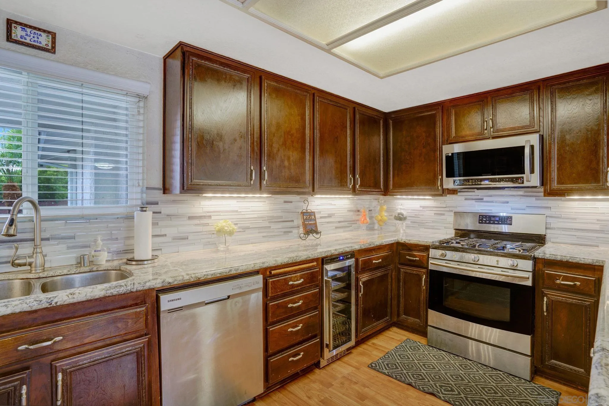 1082 Fulton Road San Marcos, CA 92069 - Photo 18 of 38 a kitchen with stainless steel appliances granite countertop a stove and a sink