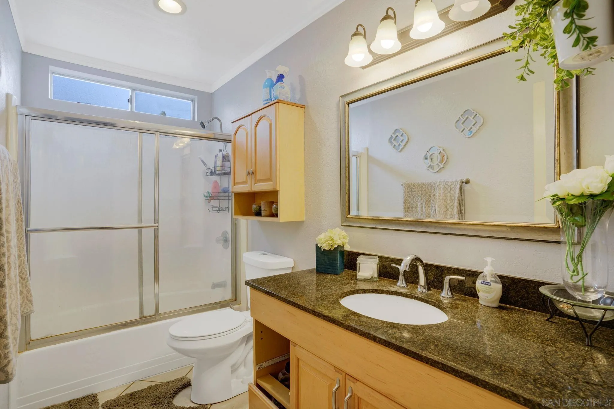 1082 Fulton Road San Marcos, CA 92069 - Photo 20 of 38 a bathroom with a granite countertop sink toilet and shower