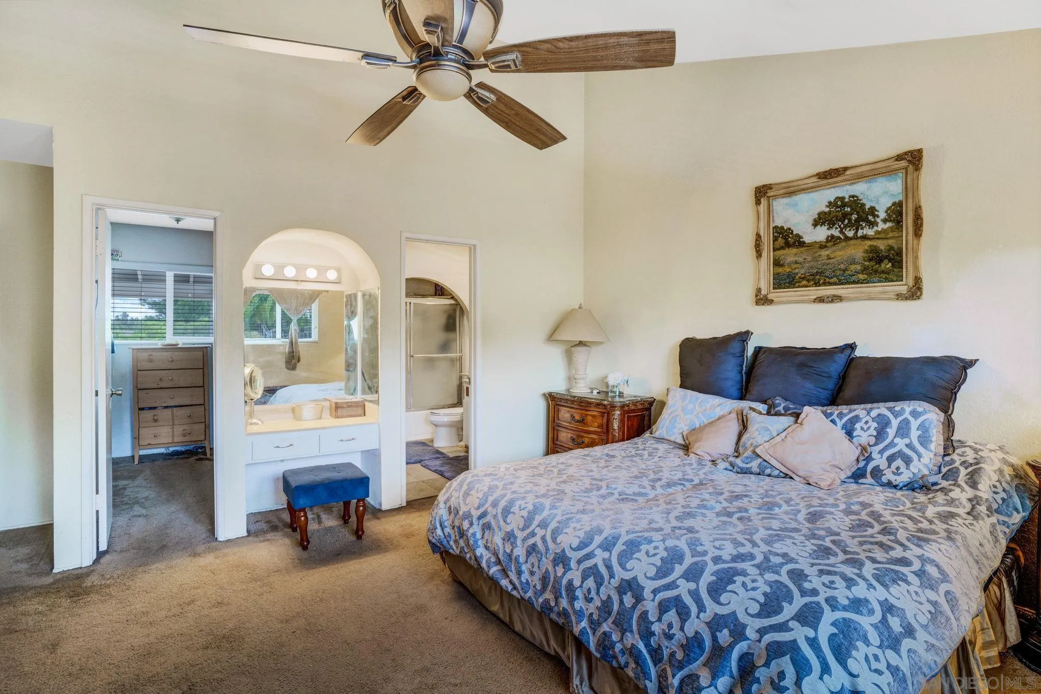1082 Fulton Road San Marcos, CA 92069 - Photo 25 of 38 a bedroom with a bed a chandelier and a painting on the wall