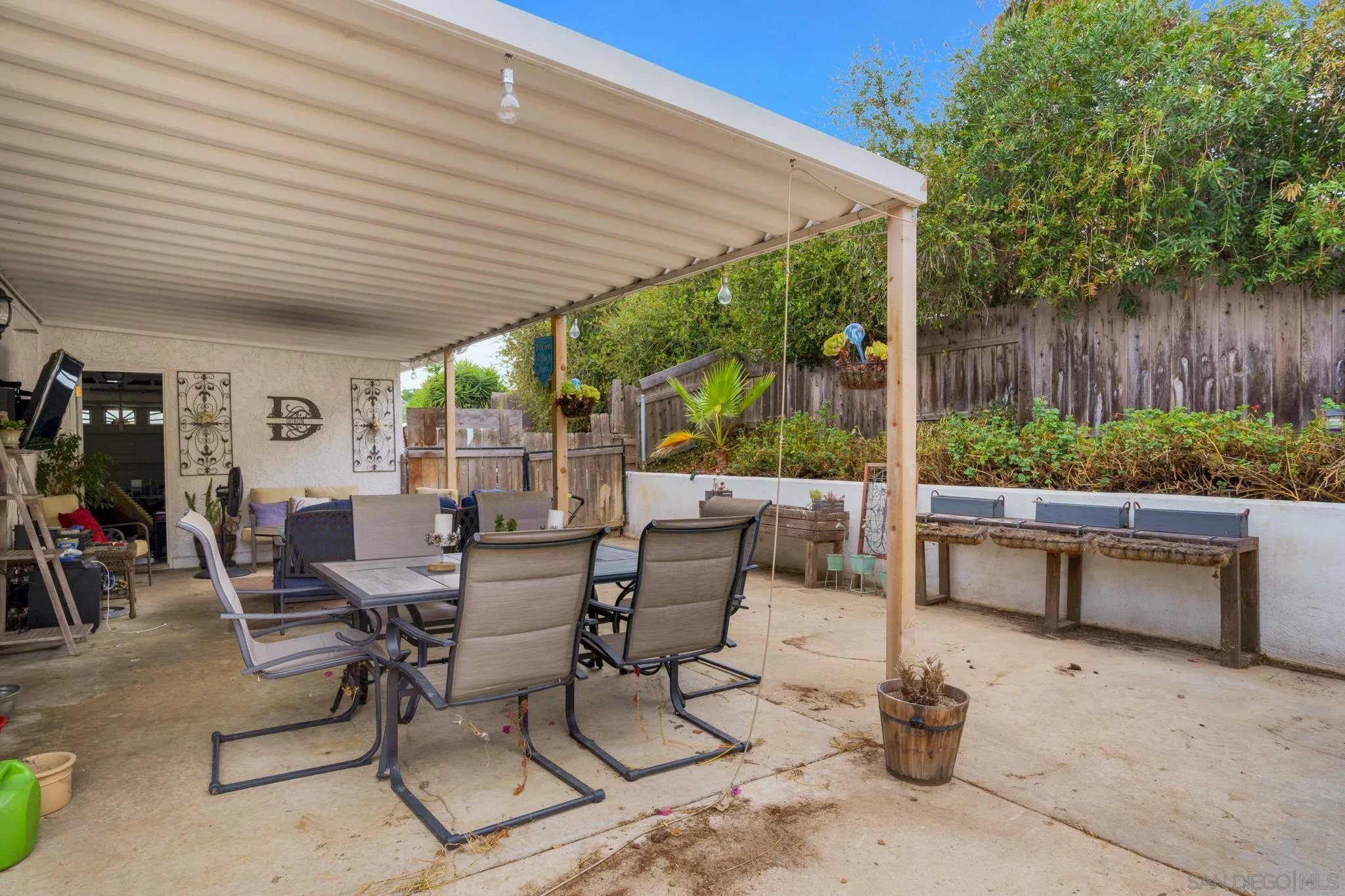 1082 Fulton Road San Marcos, CA 92069 - Photo 33 of 38 a view of a patio with a dining table and chairs with wooden floor and fence
