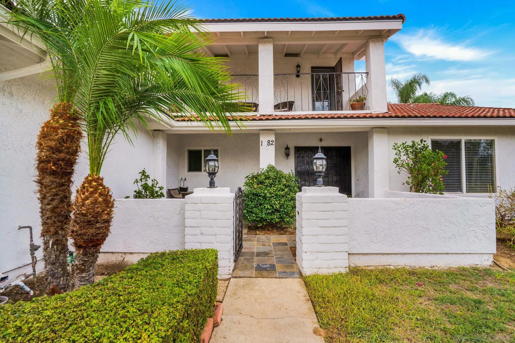 1082 Fulton Road San Marcos, CA 92069 - Photo 37 of 38 a view of a house with potted plants and a large tree