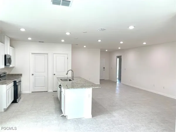 a kitchen with a sink stainless steel appliances and cabinets