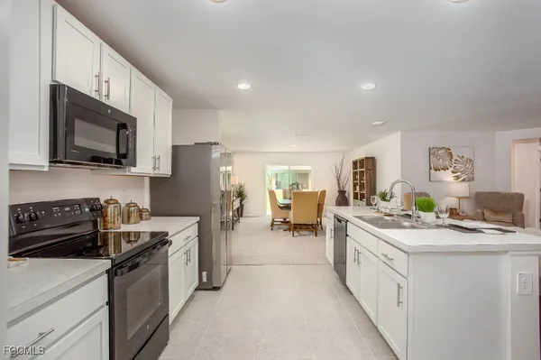 a kitchen with a sink stove and cabinets