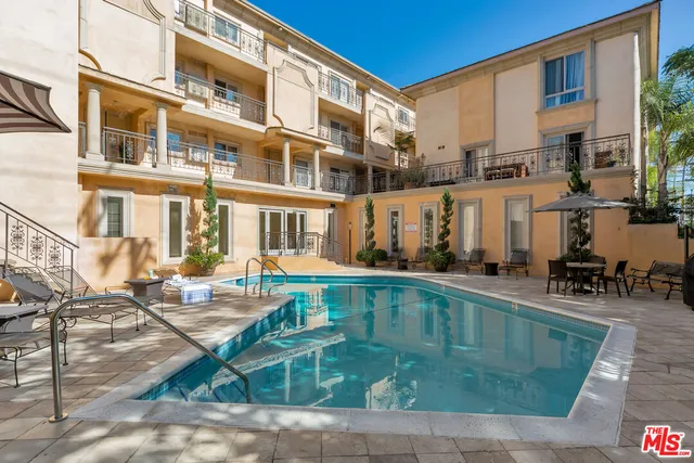 a view of a swimming pool with outdoor seating