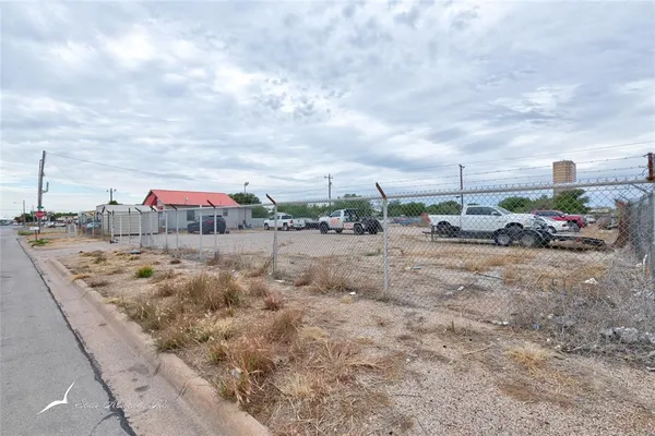 a view of car parked on road with building