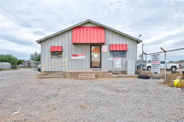 a view of a house with a yard and sitting area