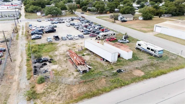 an aerial view of a house with a yard and lake view