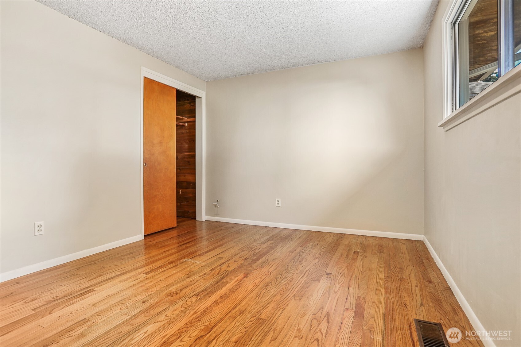 5626 Beverly Lane Everett, WA 98203 - Photo 23 of 38 a view of an empty room with wooden floor and a window