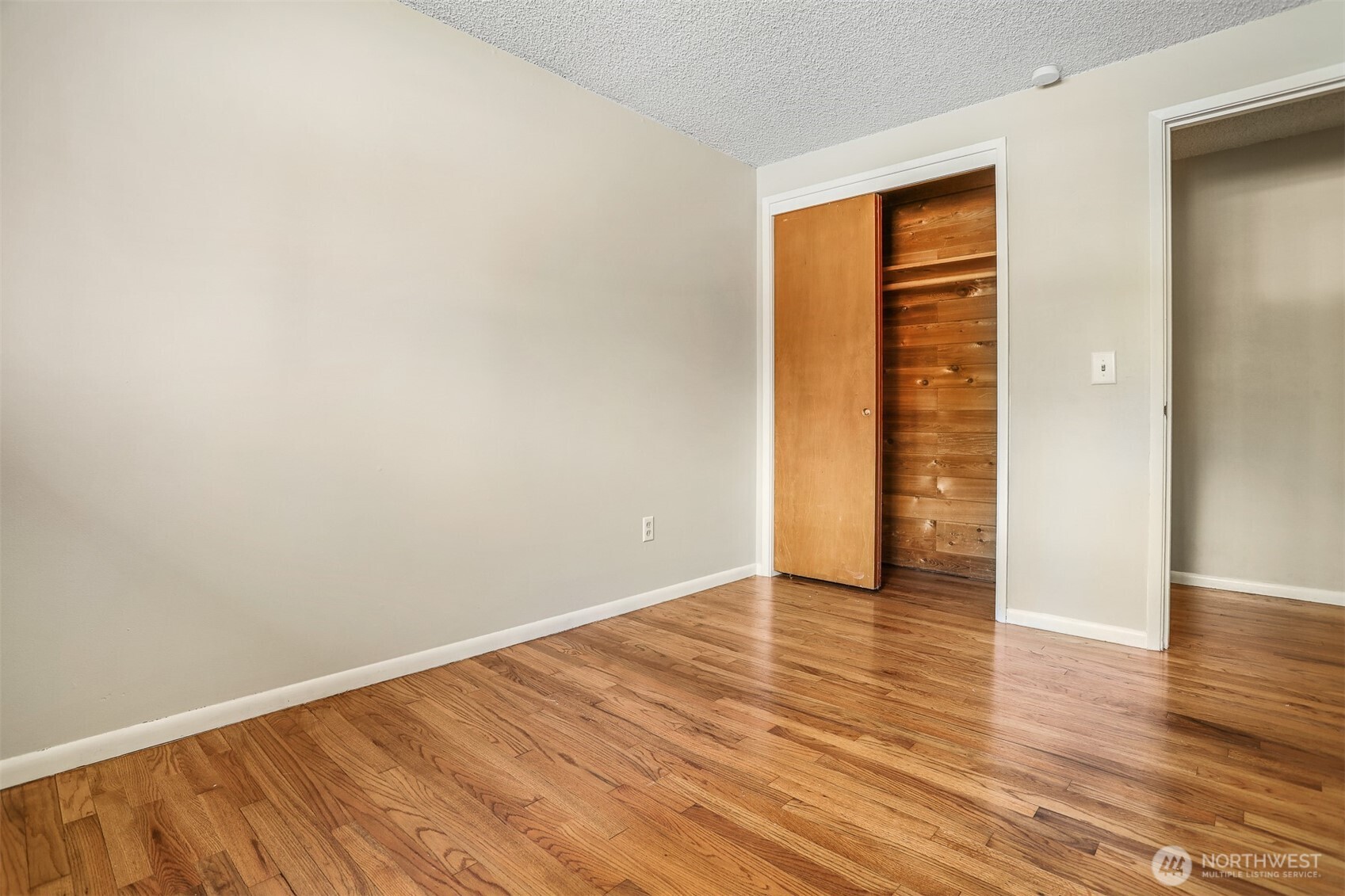 5626 Beverly Lane Everett, WA 98203 - Photo 25 of 38 a view of an empty room with wooden floor and a window