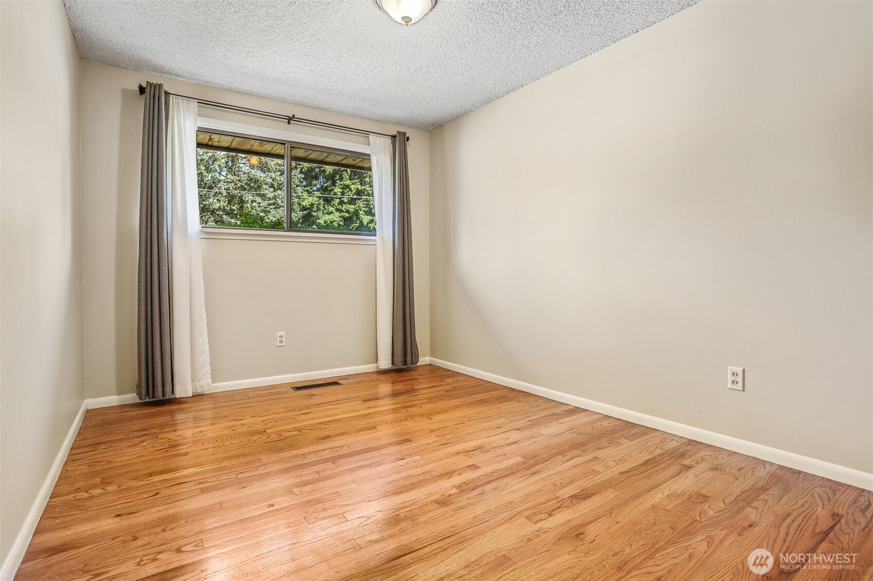 5626 Beverly Lane Everett, WA 98203 - Photo 26 of 38 a view of an empty room with wooden floor
