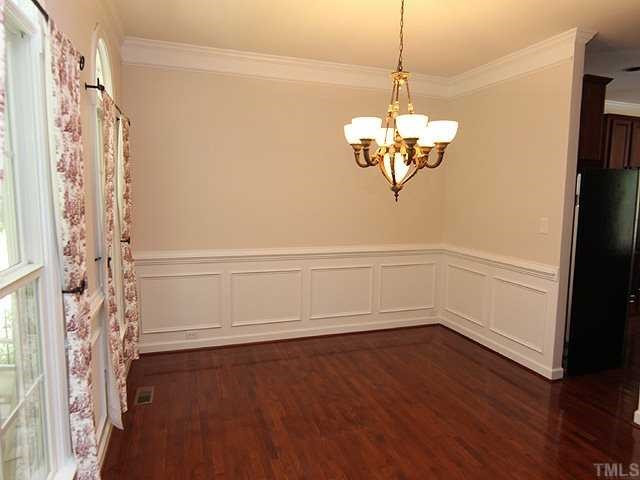 5204 6 Pence Court Raleigh, NC 27613 - Photo 3 of 17 Lovely dining room with hardwood floors, heavy crown molding, and wainscotting. Dining Room