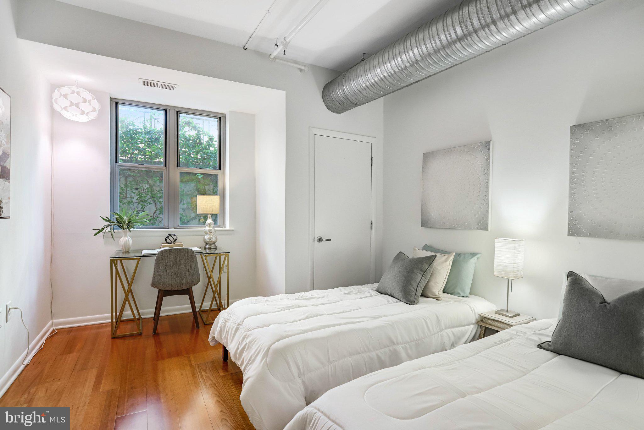 1300 N Street Northwest, Unit 15 Washington, DC 20005 - Photo 14 of 51 a bedroom with a bed and a chair