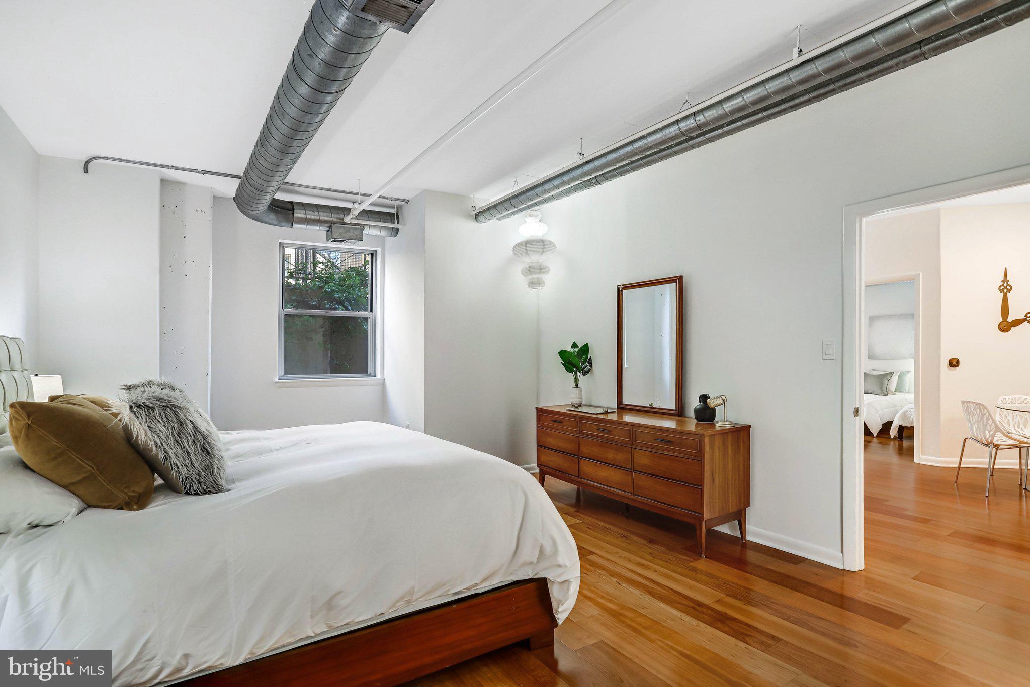 1300 N Street Northwest, Unit 15 Washington, DC 20005 - Photo 19 of 51 a bedroom with a bed and a dresser