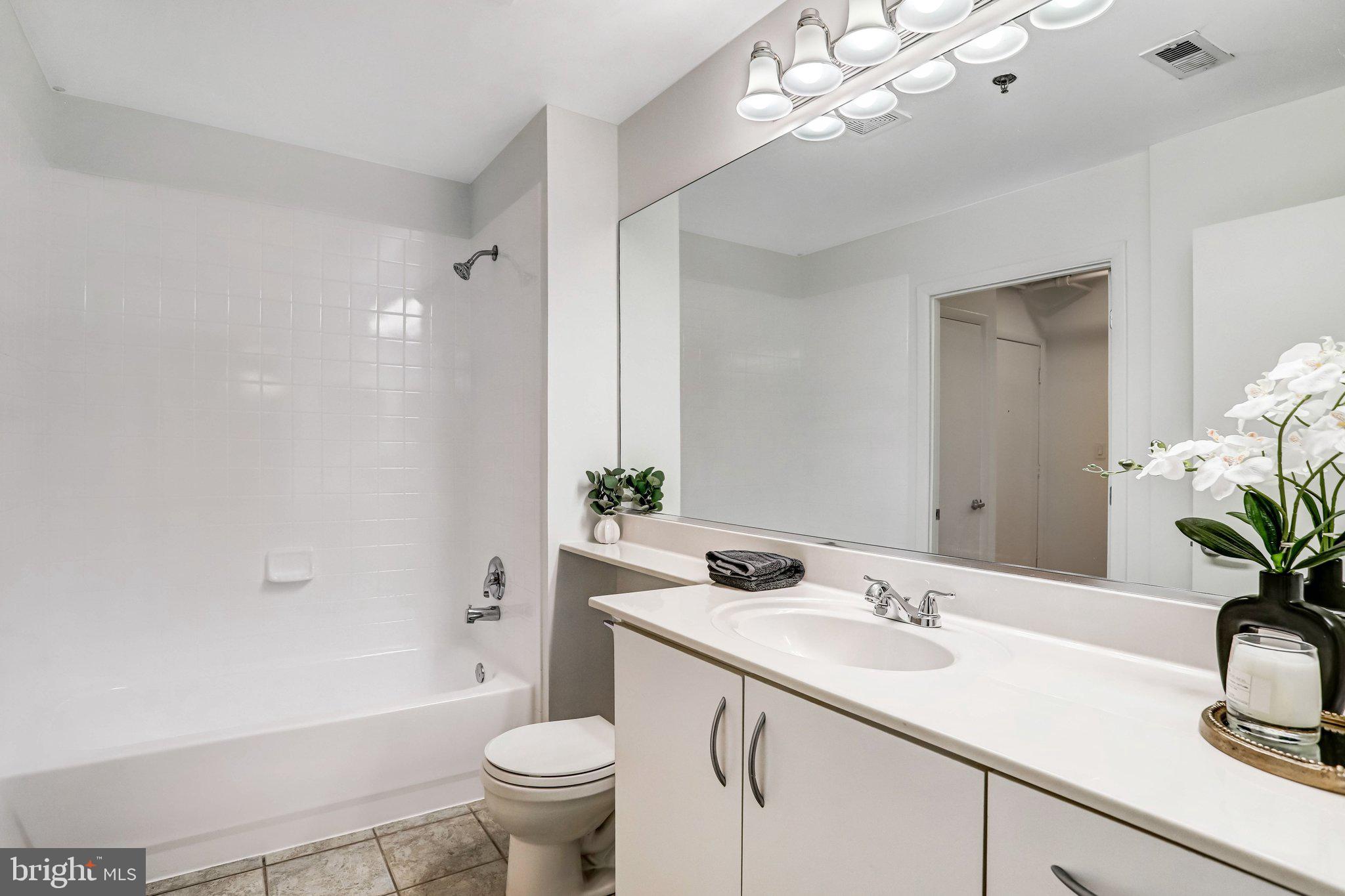 1300 N Street Northwest, Unit 15 Washington, DC 20005 - Photo 24 of 51 a bathroom with a sink a toilet and a mirror