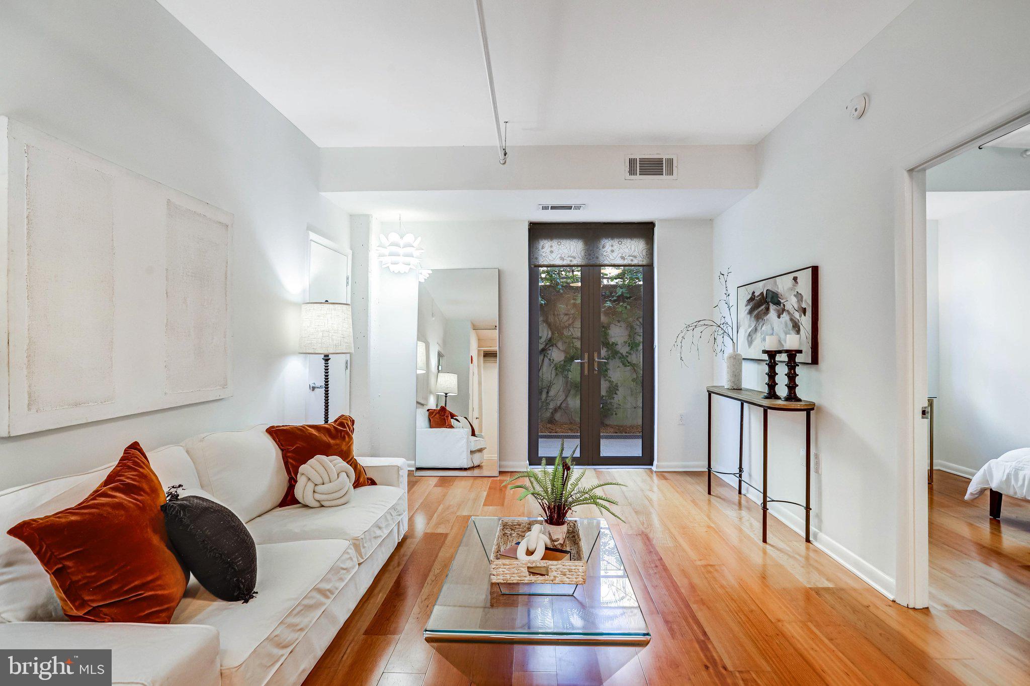 1300 N Street Northwest, Unit 15 Washington, DC 20005 - Photo 26 of 51 a living room with furniture and wooden floor