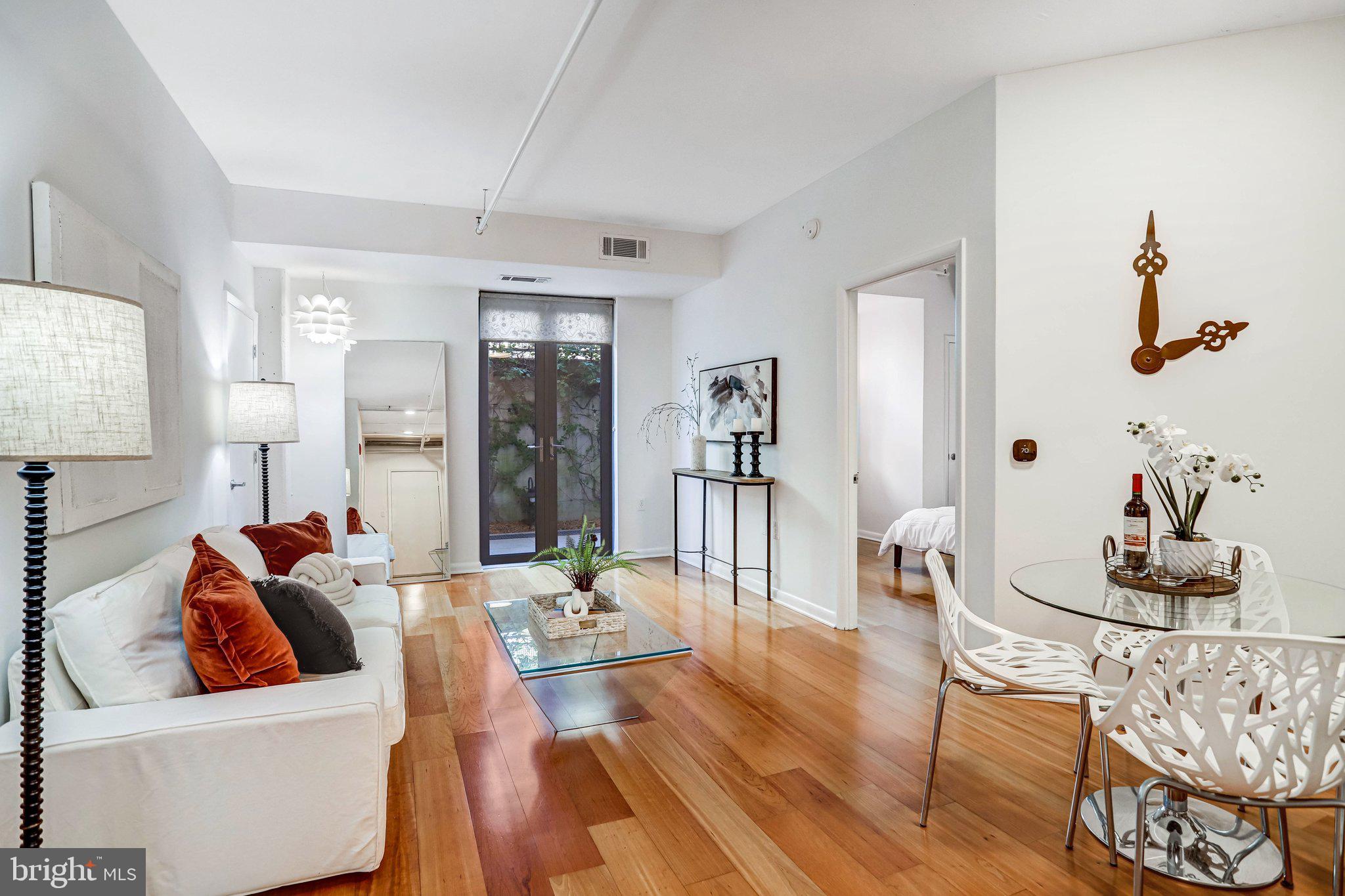 1300 N Street Northwest, Unit 15 Washington, DC 20005 - Photo 30 of 51 a living room with furniture and wooden floor