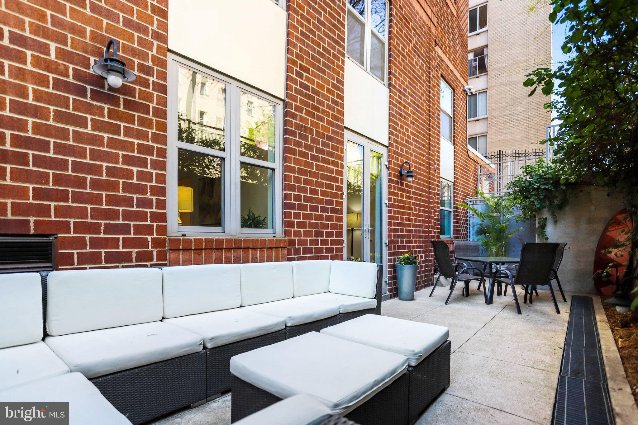 1300 N Street Northwest, Unit 15 Washington, DC 20005 - Photo 34 of 51 a view of a patio with couches and a potted plant on a table