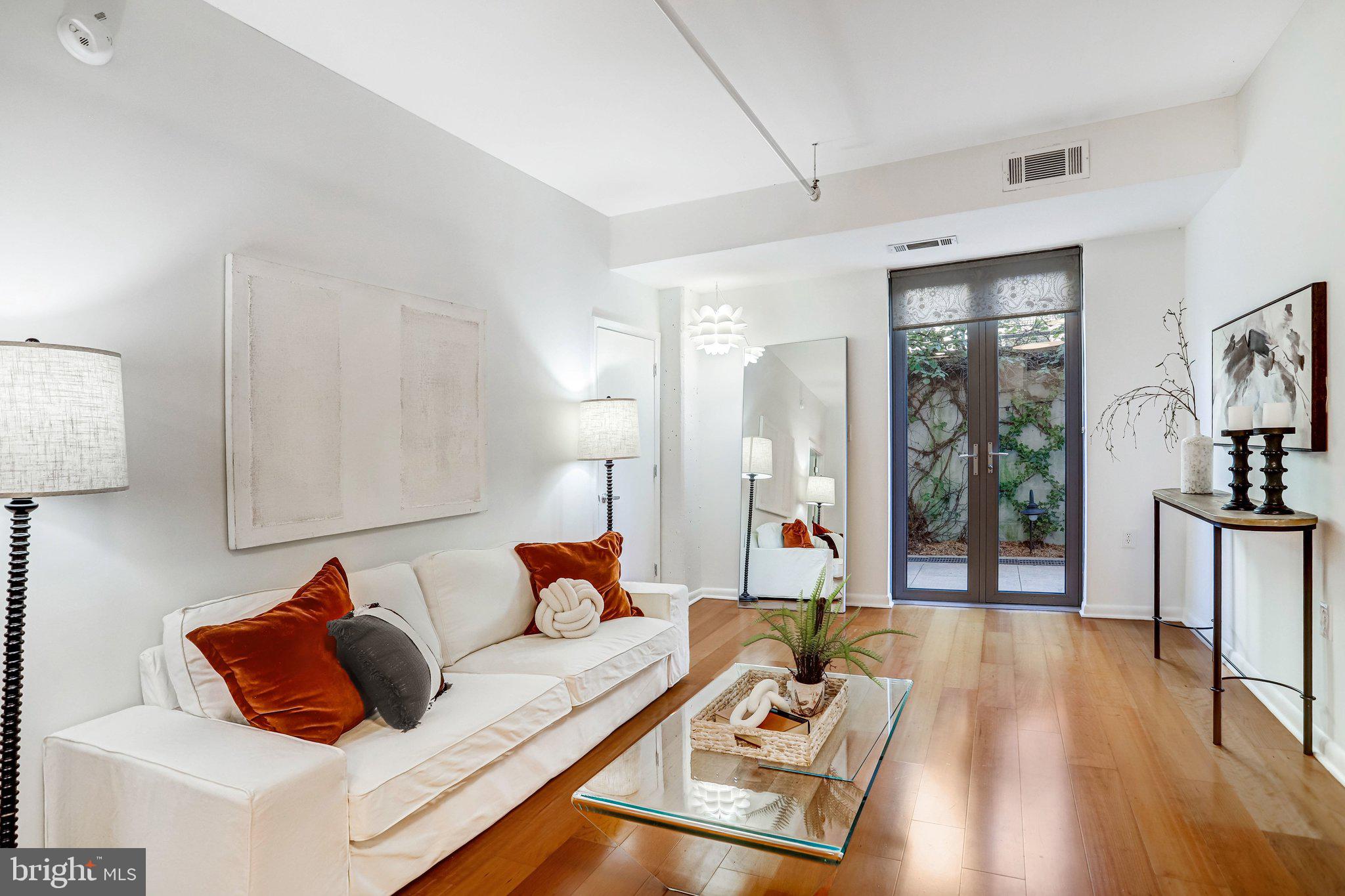 1300 N Street Northwest, Unit 15 Washington, DC 20005 - Photo 5 of 51 a living room with furniture and a wooden floor