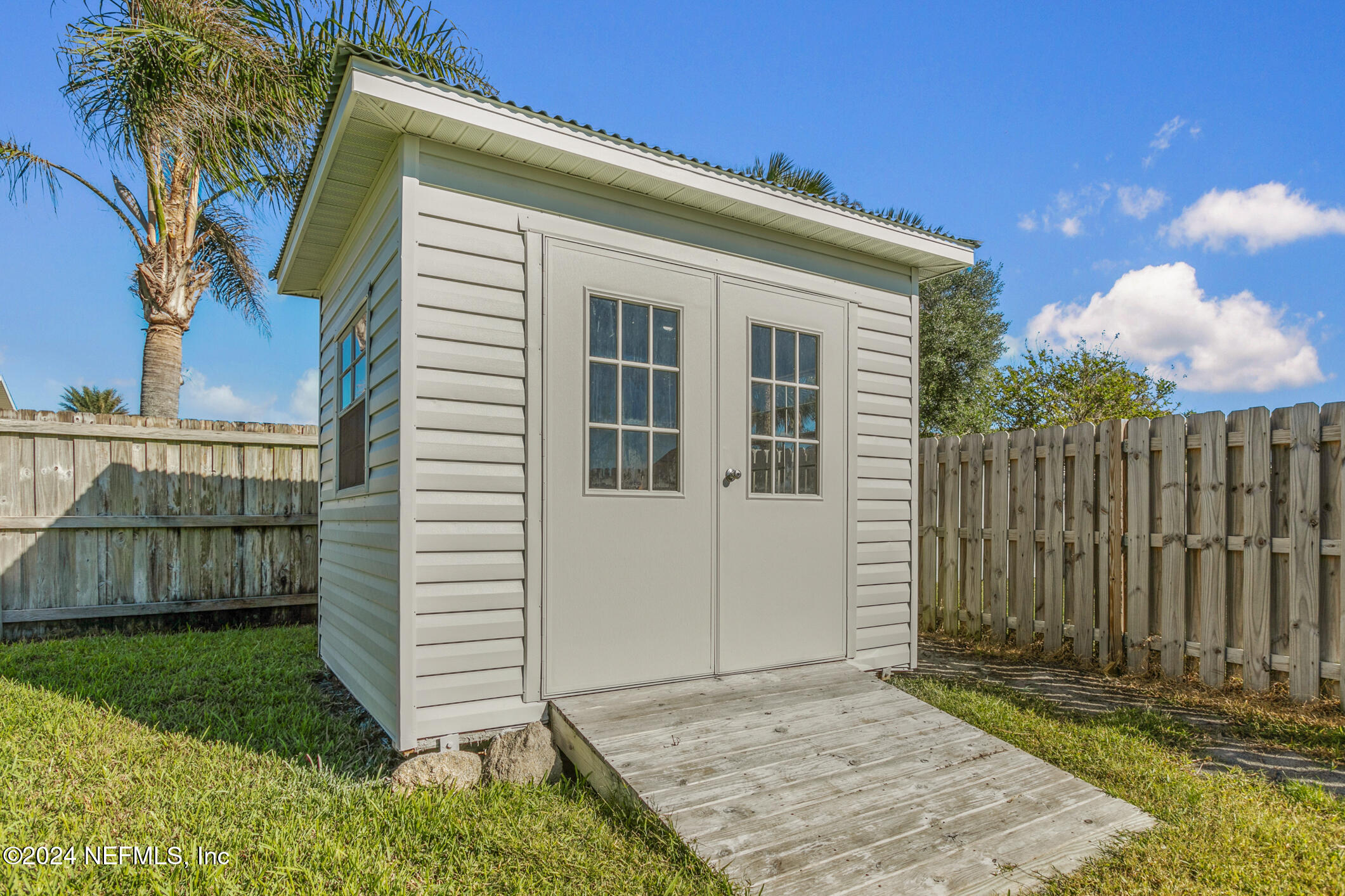 47 Sandpiper Drive St. Augustine, FL 32080 - Photo 29 of 61 a view of a house with a small yard and wooden fence