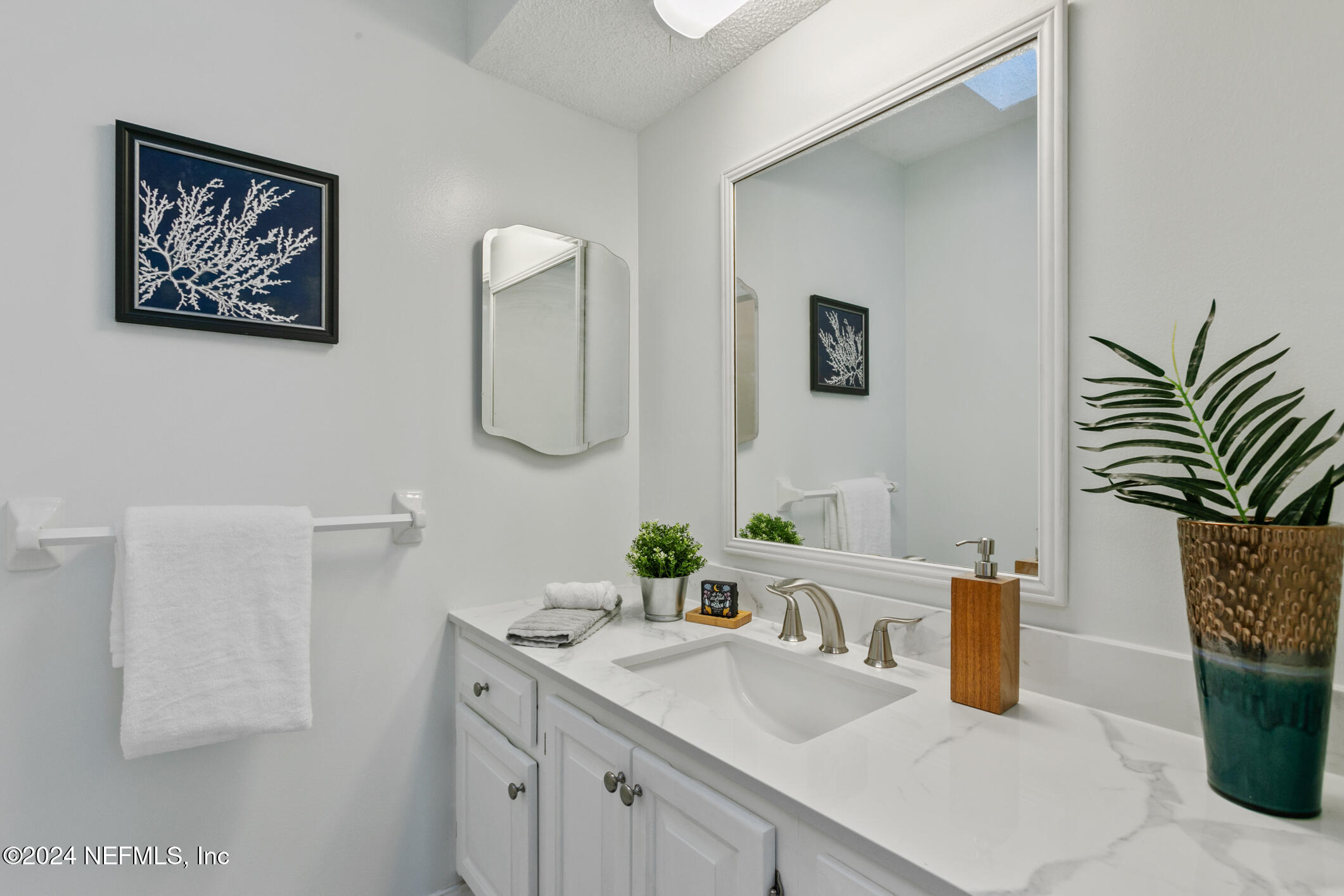 47 Sandpiper Drive St. Augustine, FL 32080 - Photo 36 of 61 a bathroom with a sink a mirror and vanity