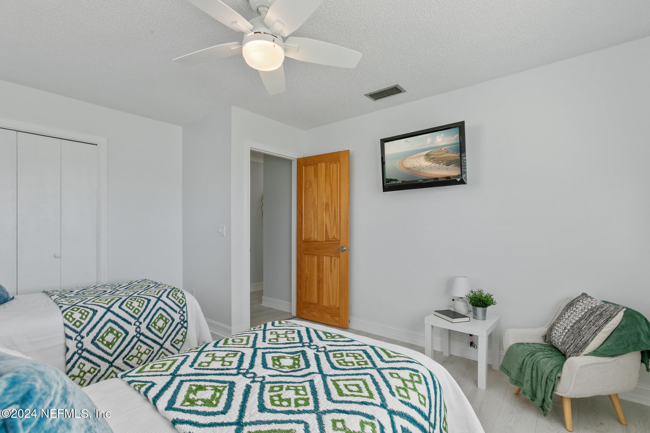 47 Sandpiper Drive St. Augustine, FL 32080 - Photo 39 of 61 a bedroom with a bed and a chandelier