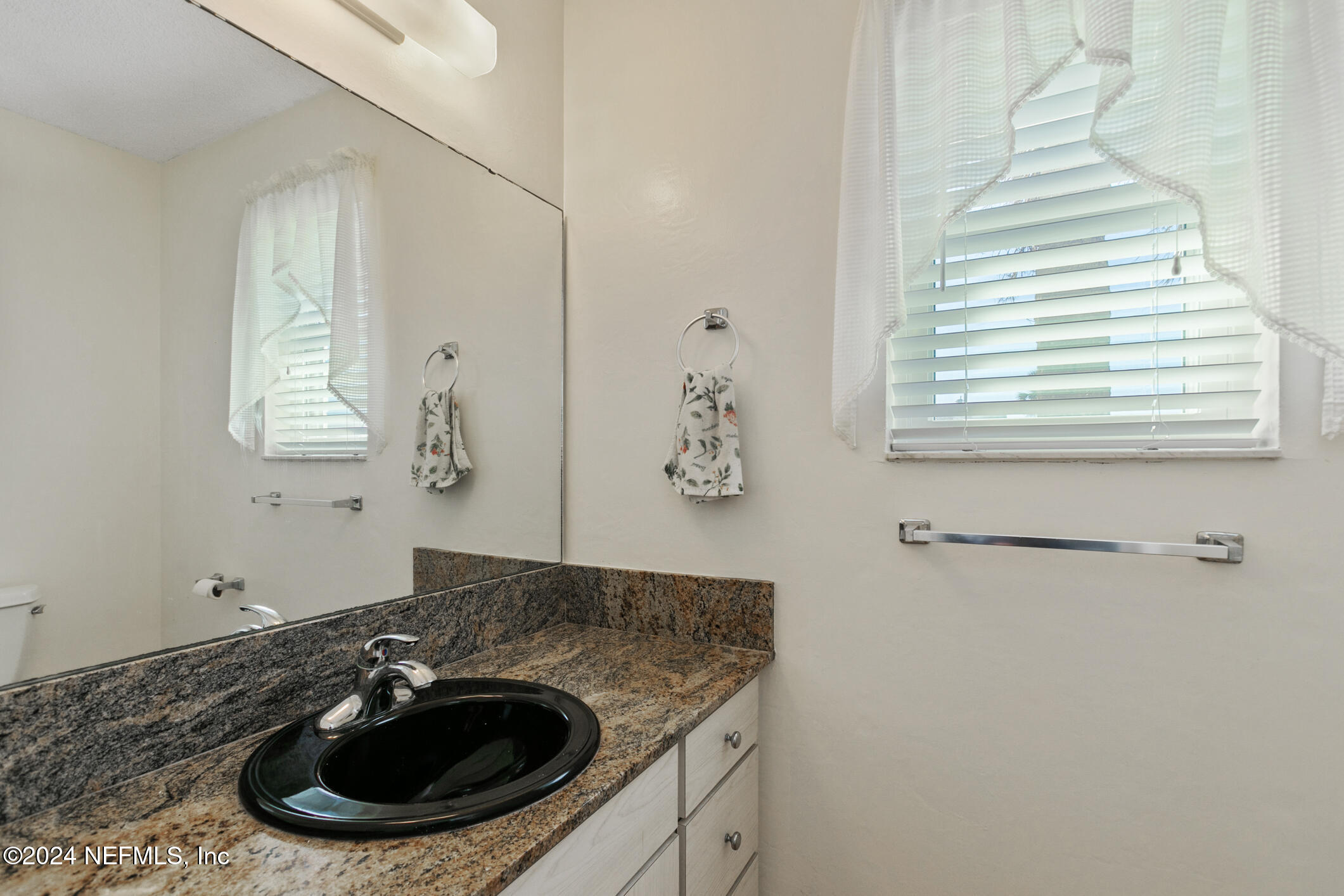47 Sandpiper Drive St. Augustine, FL 32080 - Photo 42 of 61 a bathroom with a sink and a mirror