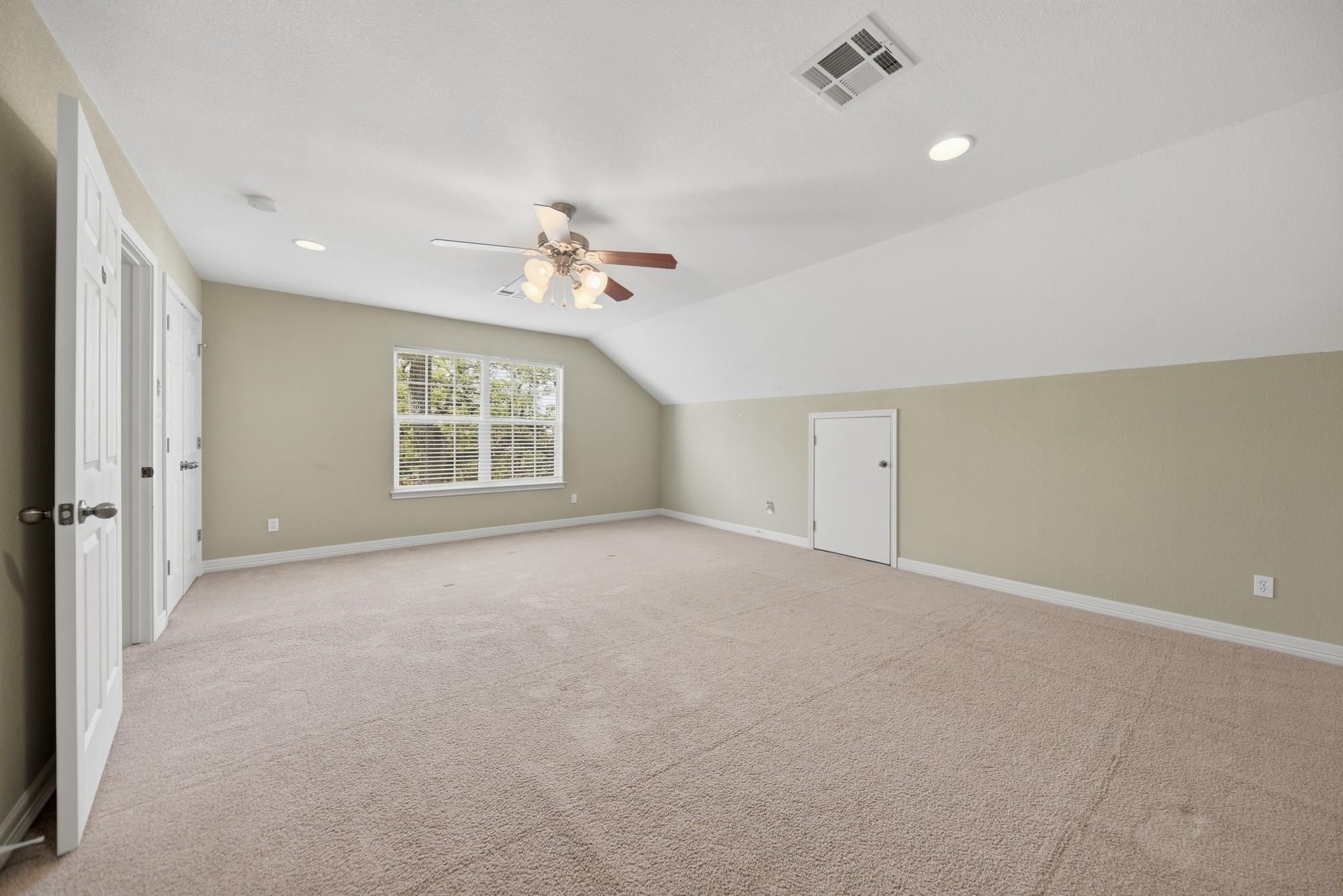 350 Owl Creek Road Giddings, TX 78942 - Photo 12 of 29 an empty room with windows and ceiling fan