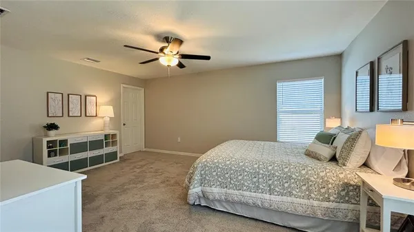 a bedroom with a bed and a tv