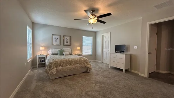a bedroom with a bed and a chandelier