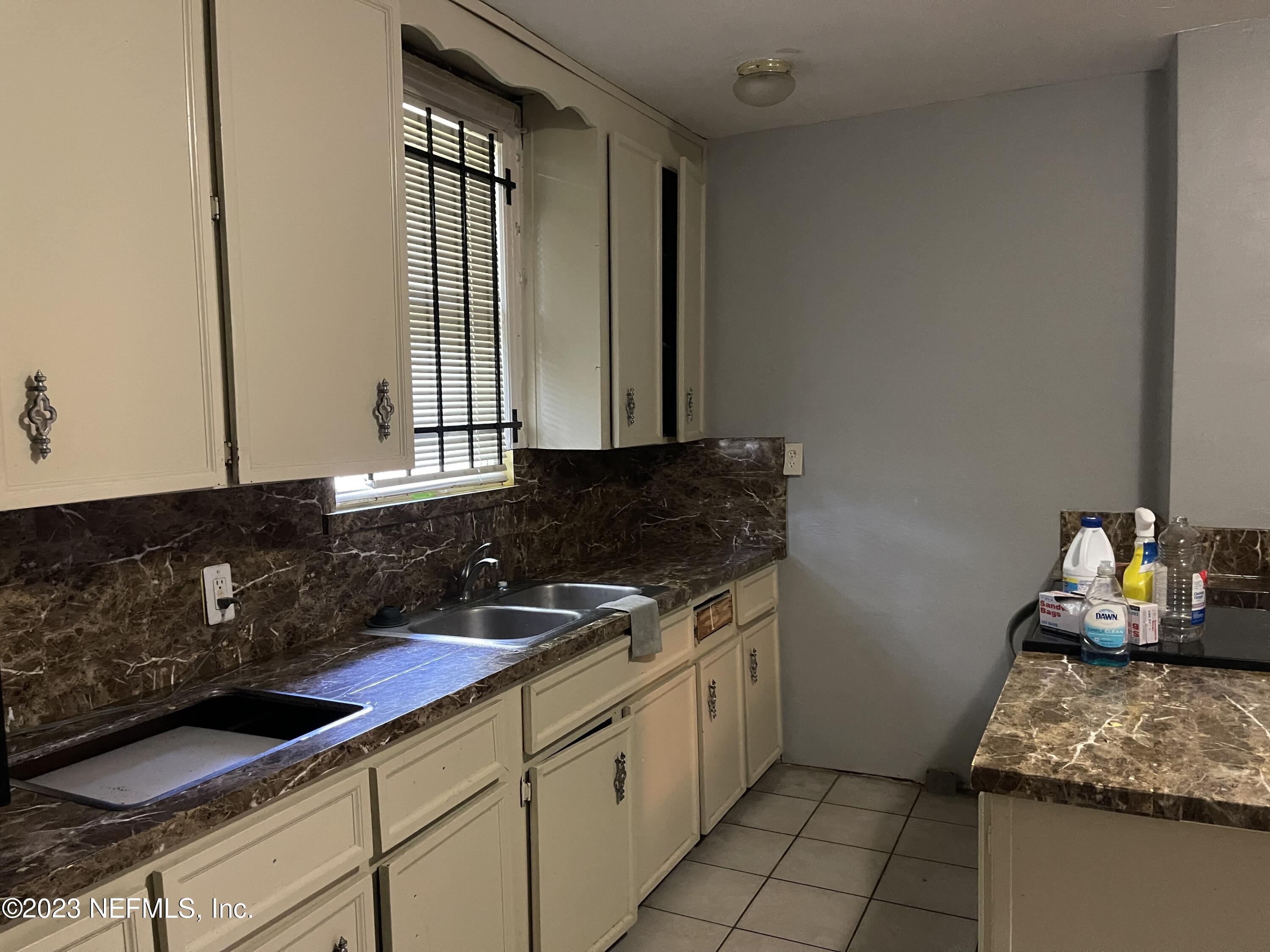 1124 Kenmore Street Jacksonville, FL 32208 - Photo 8 of 11 a kitchen with a sink and cabinets