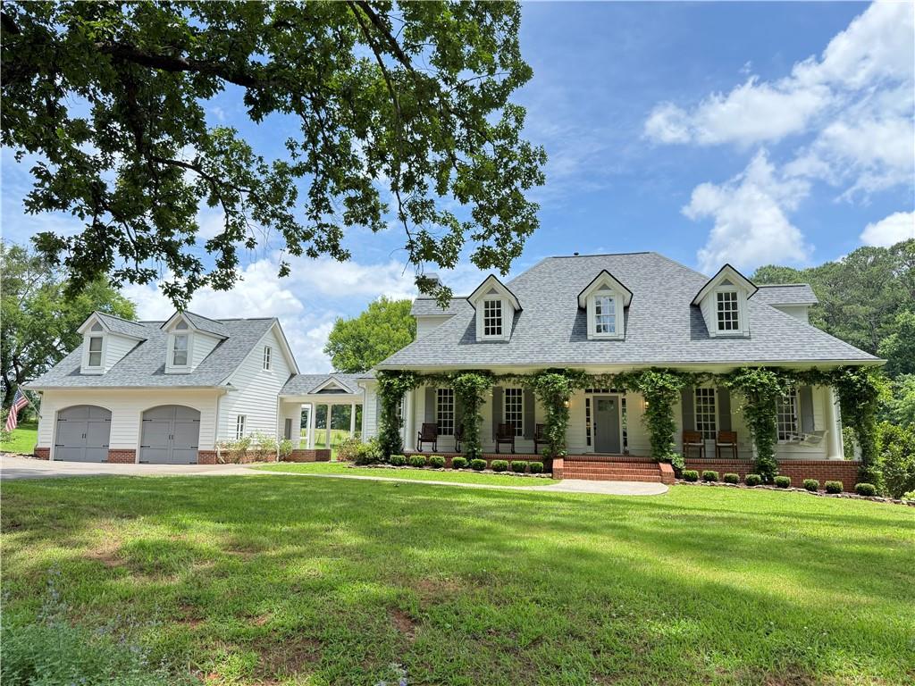548 Tamarack Trail Canton, GA 30115 - Photo 1 of 83 a front view of a house with a garden
