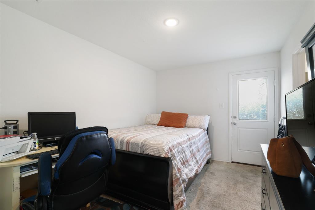1445 Sterling Way Ferris, TX 75125 - Photo 11 of 17 Bedroom featuring an office area and light colored carpet