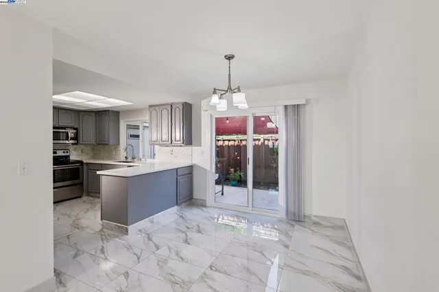 a large kitchen with a refrigerator and countertop