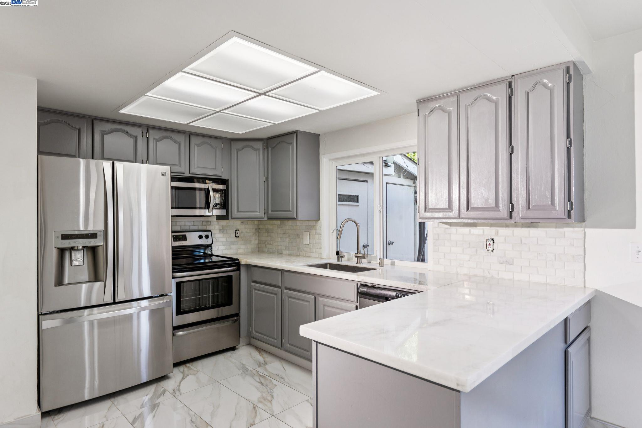 560 La Copita Court San Ramon, CA 94583 - Photo 12 of 40 a kitchen with stainless steel appliances granite countertop a sink stove and refrigerator
