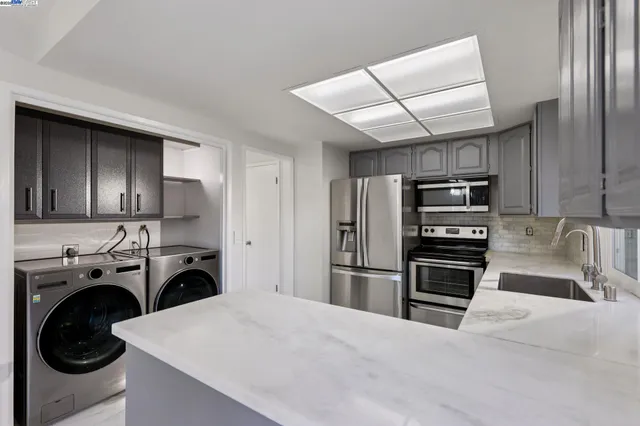 a kitchen with refrigerator a washer and dryer