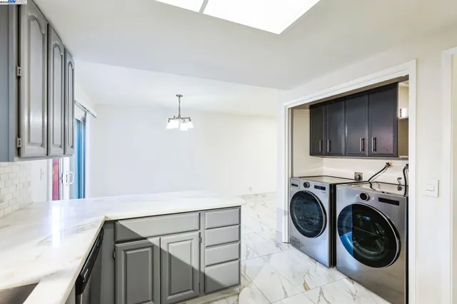 a view of a hallway with washer and dryer