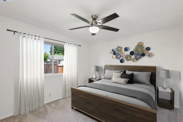 a bedroom with a bed and a window