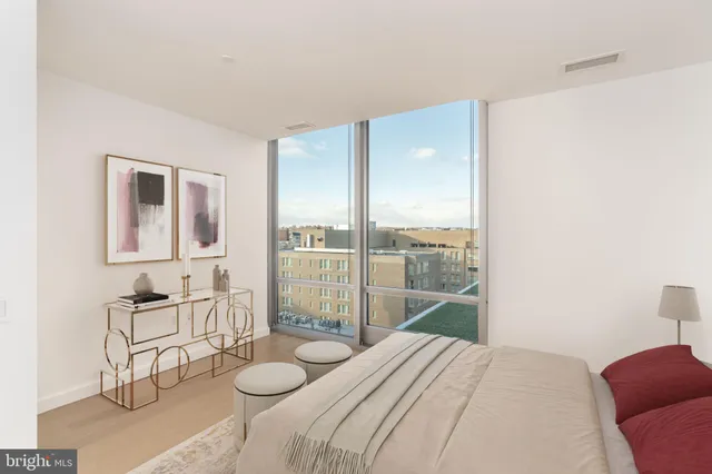 a bedroom with a bed and glass window