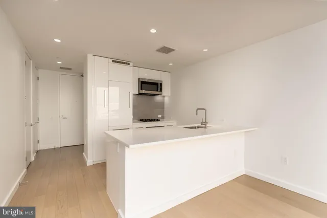 a view of a sink and a refrigerator in a room