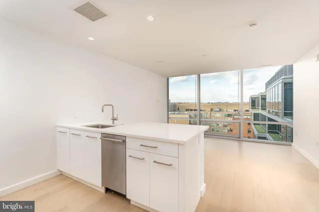 a kitchen with a sink cabinets and wooden floor