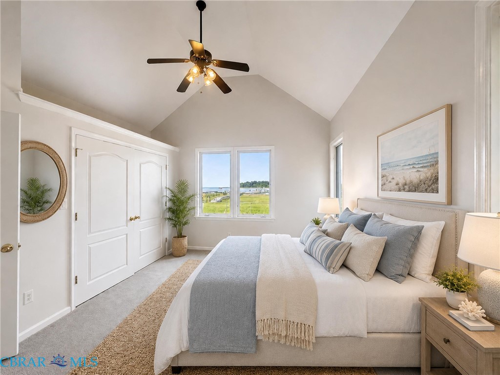 1214 Dandy Loop Road Yorktown, VA 23692 - Photo 35 of 65 a bedroom with a bed and a chandelier