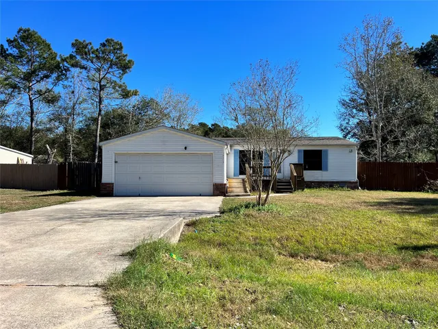a house view with a sitting space and garden