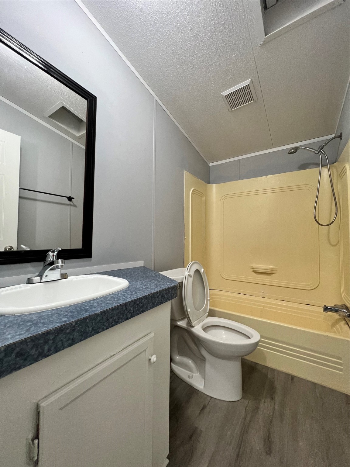 16105 Lone Star Ranch Drive Conroe, TX 77302 - Photo 22 of 24 a bathroom with a granite countertop sink toilet a mirror and shower