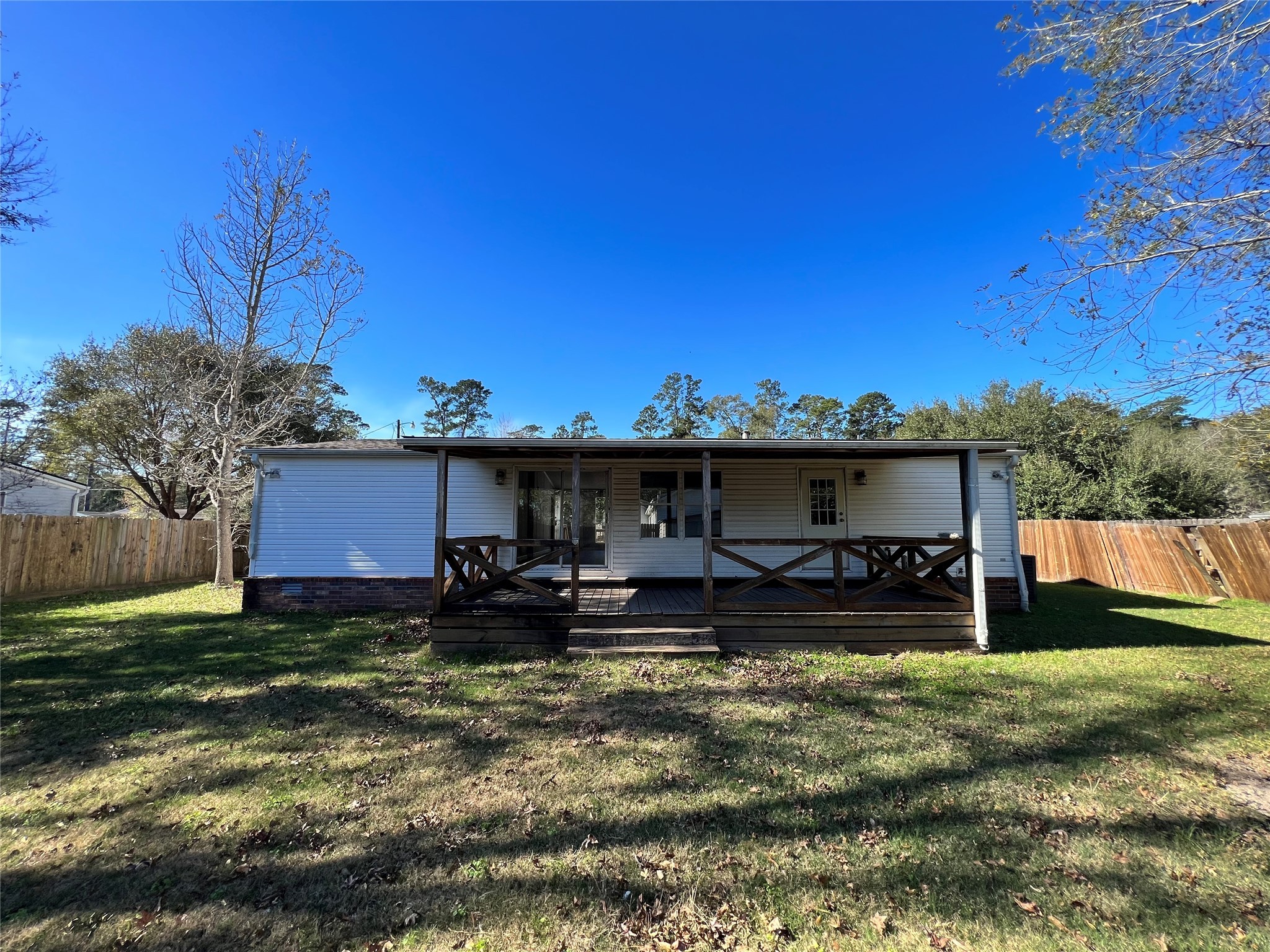 16105 Lone Star Ranch Drive Conroe, TX 77302 - Photo 24 of 24 a view of a house with a yard and a tree