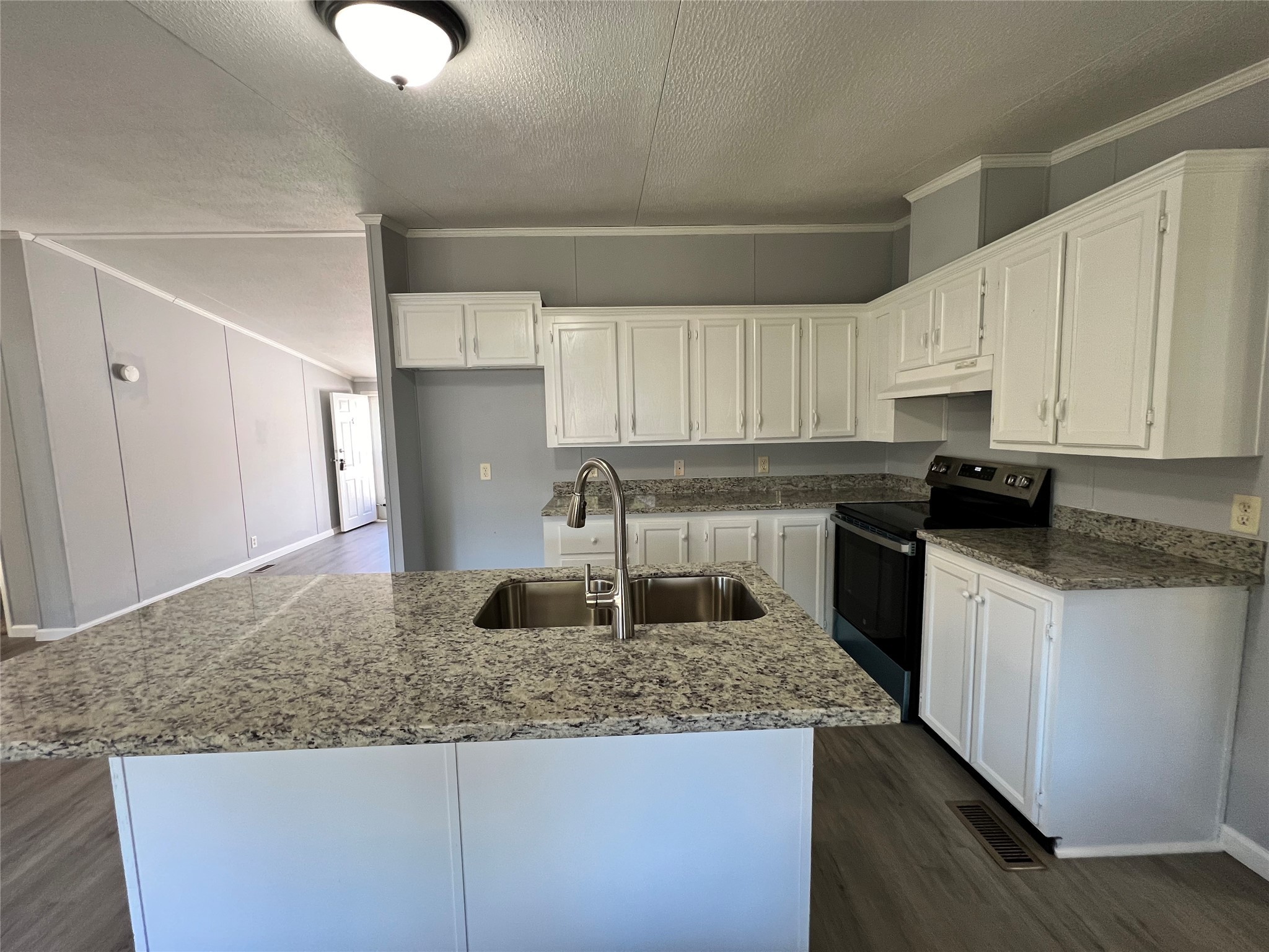 16105 Lone Star Ranch Drive Conroe, TX 77302 - Photo 10 of 24 a kitchen with granite countertop a sink white cabinets and stainless steel appliances