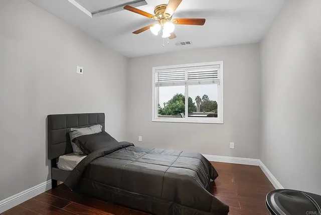 a bedroom with a bed and a window