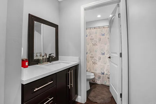 a bedroom with a bed window and walk in closet with window