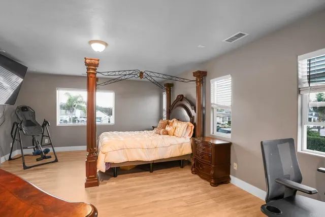 a bedroom with a bed and a mirror